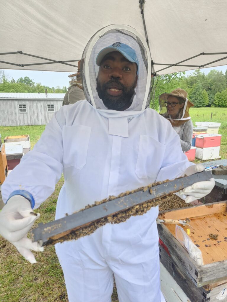 Taiwo Amoo demonstrating queen cell cup bar